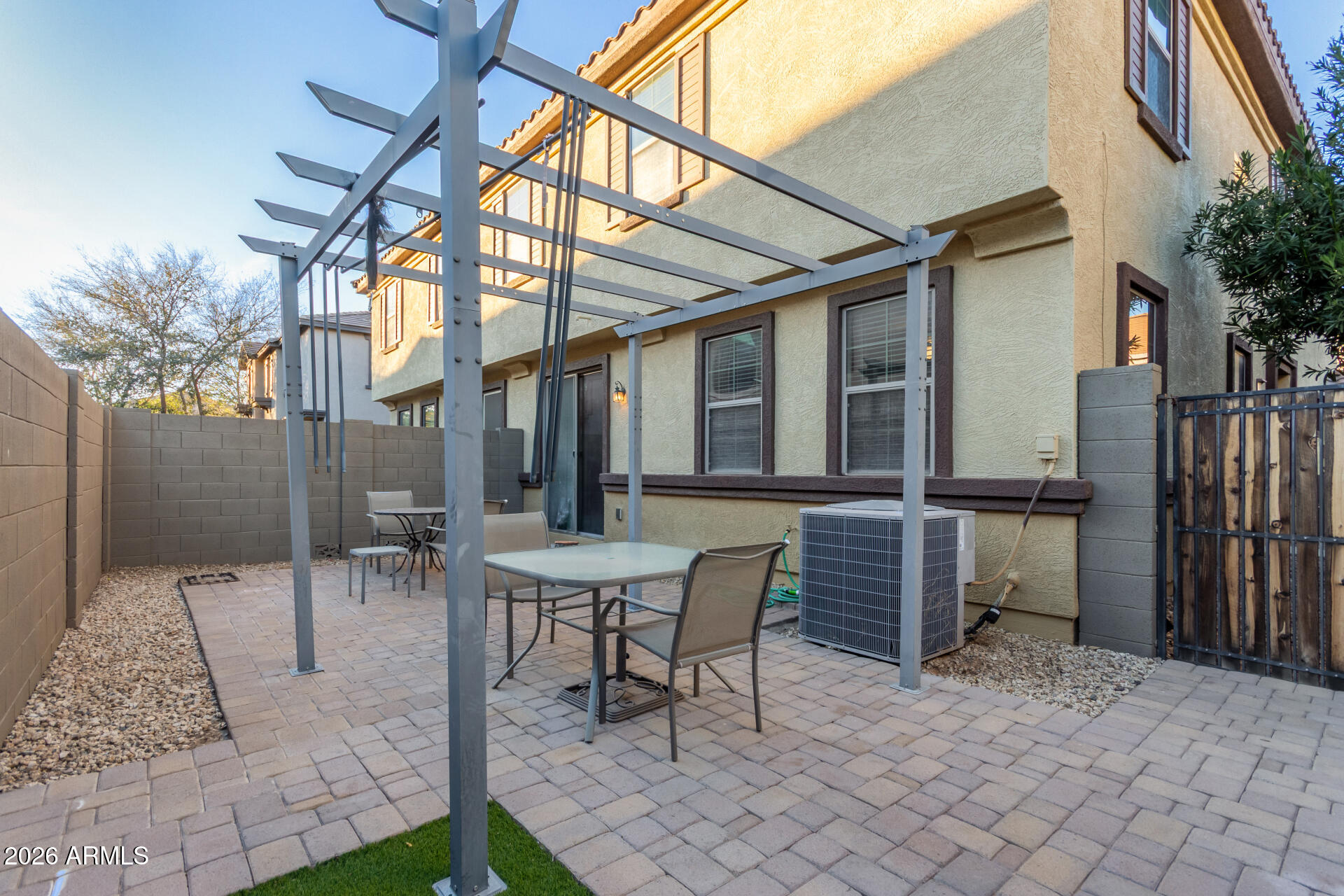 1265 South Aaron, Unit 346 Mesa, AZ 85209 - Photo 22 of 34 a backyard of a house with table and chairs
