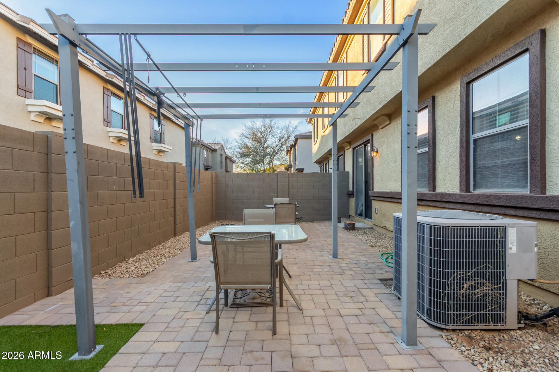 1265 South Aaron, Unit 346 Mesa, AZ 85209 - Photo 24 of 34 a view of a patio with a table and chairs and floor to ceiling window