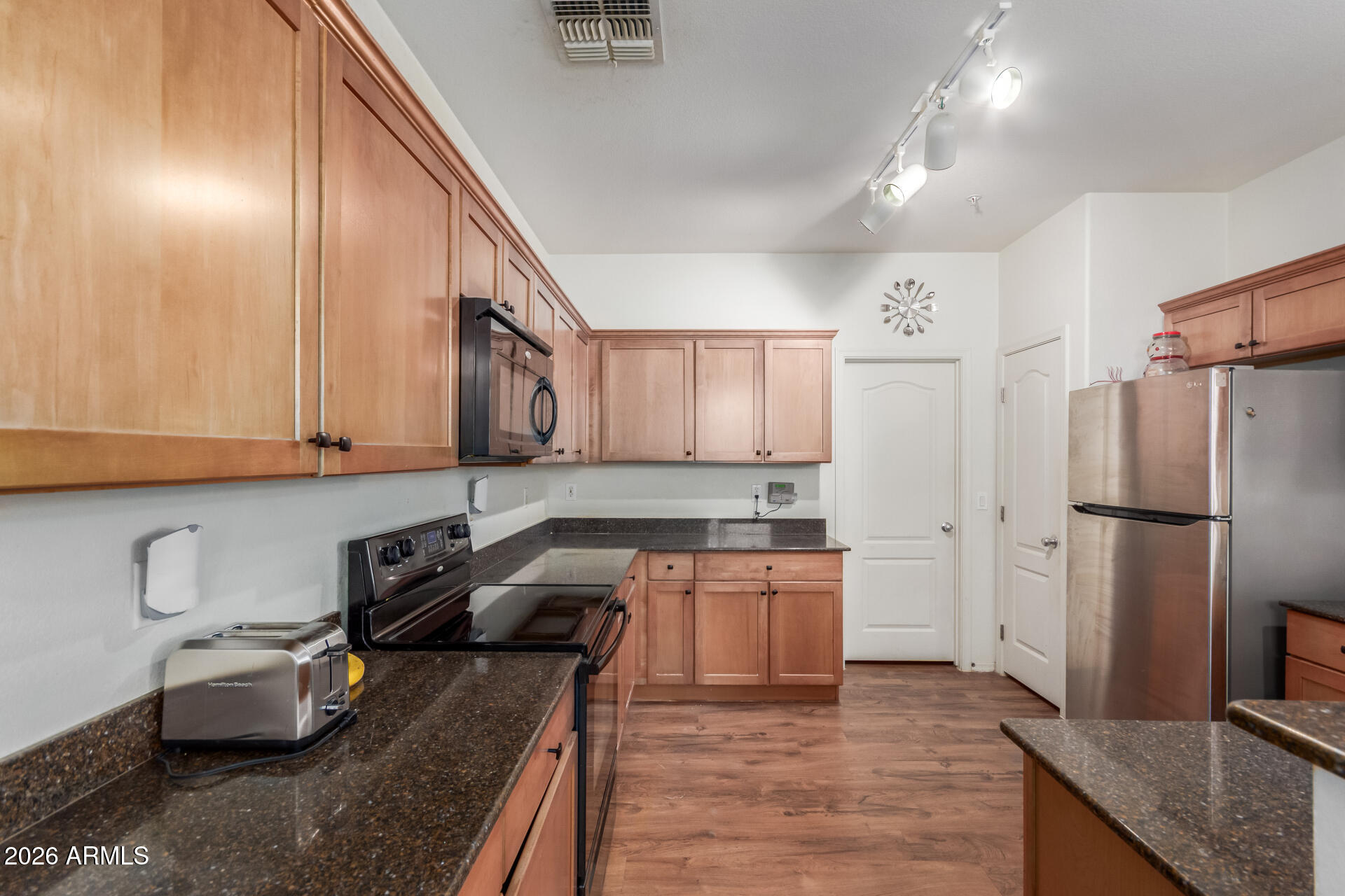 1265 South Aaron, Unit 346 Mesa, AZ 85209 - Photo 9 of 34 a kitchen with stainless steel appliances granite countertop a refrigerator sink and cabinets
