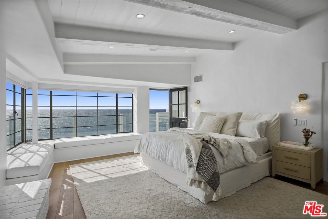 31500 Victoria Point Road Malibu, CA 90265 - Photo 22 of 53 a spacious bedroom with a bed and a large window