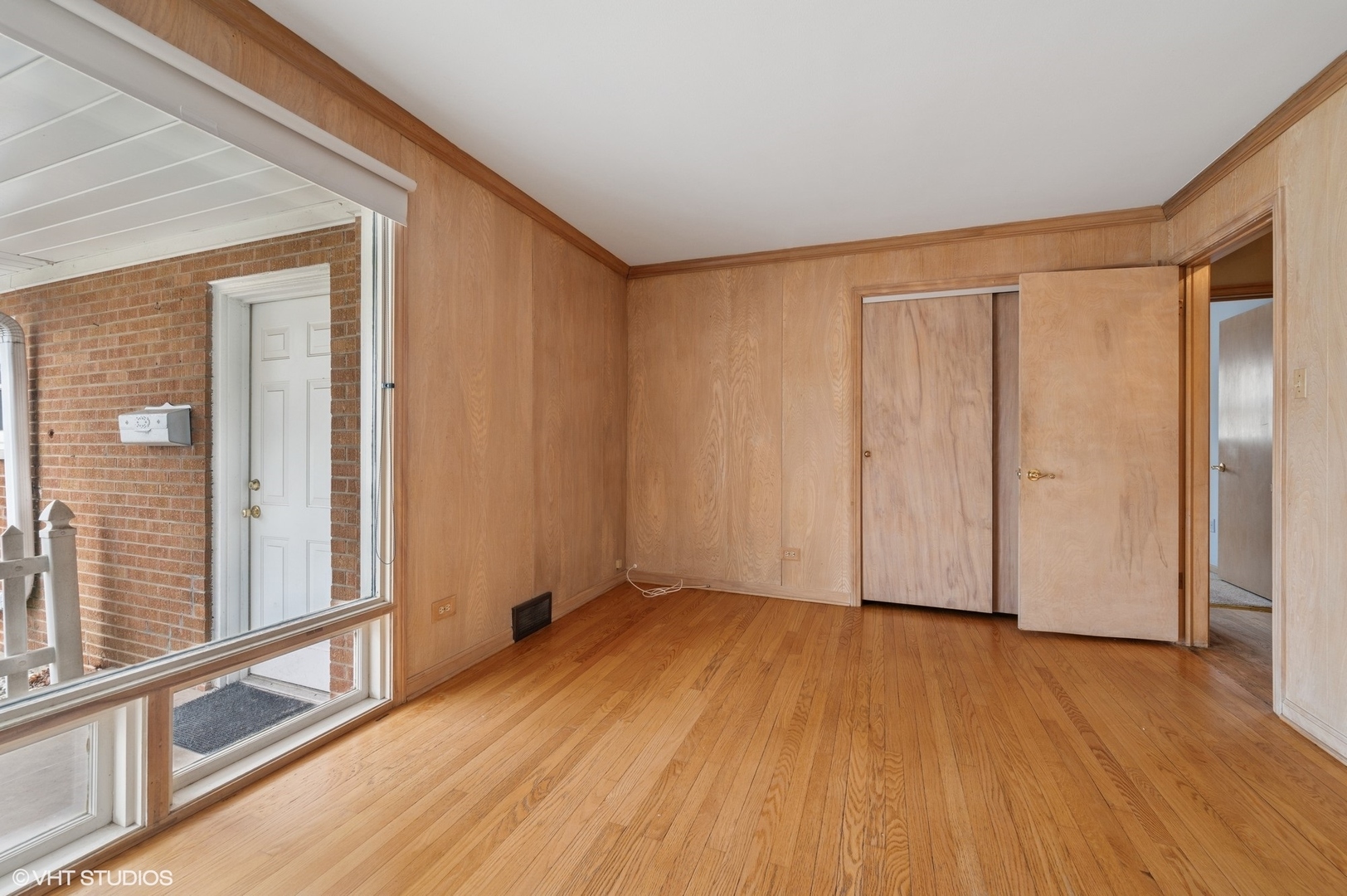 213 North Forest Avenue Mount Prospect, IL 60056 - Photo 14 of 18 a view of an empty room with wooden floor and a window