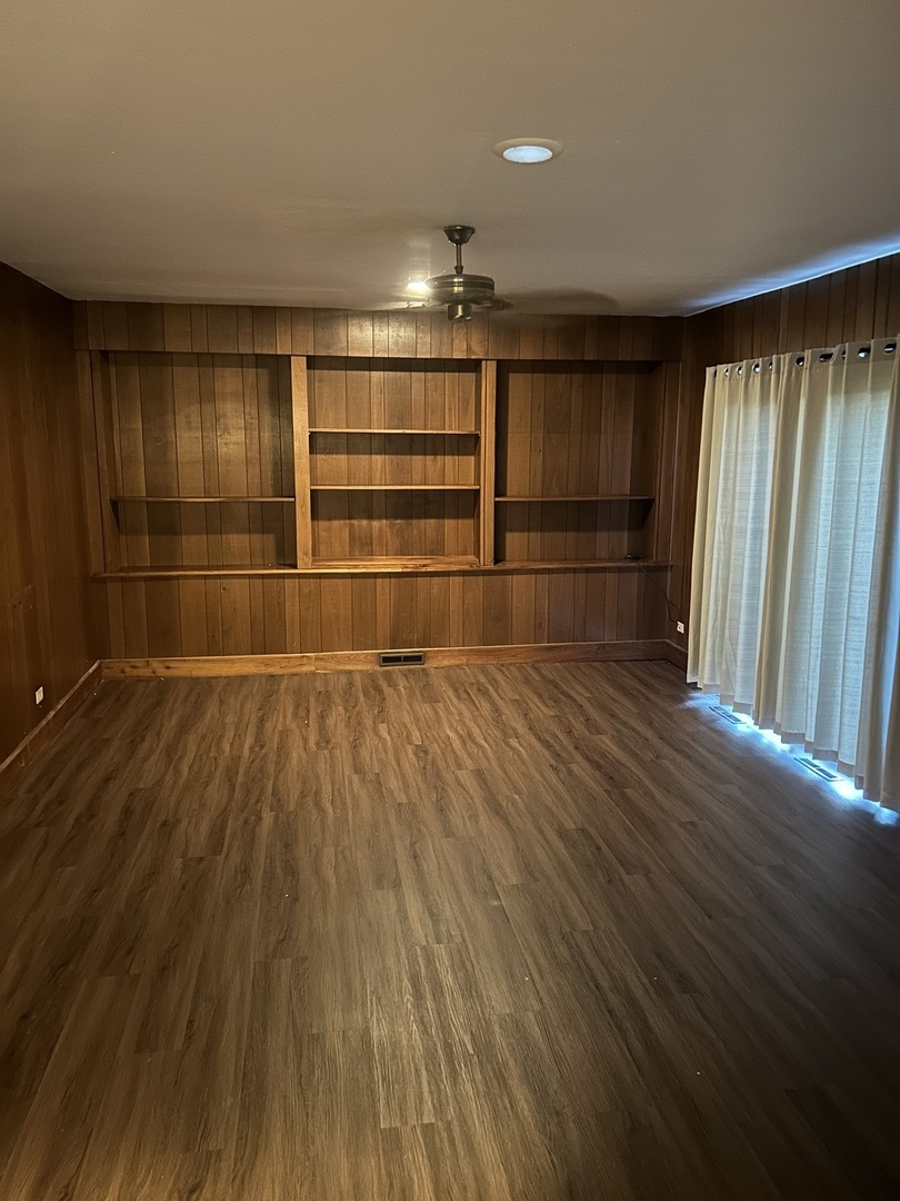 1125 Morningside Drive Elgin, IL 60123 - Photo 21 of 42 wooden floor in an empty room with a window
