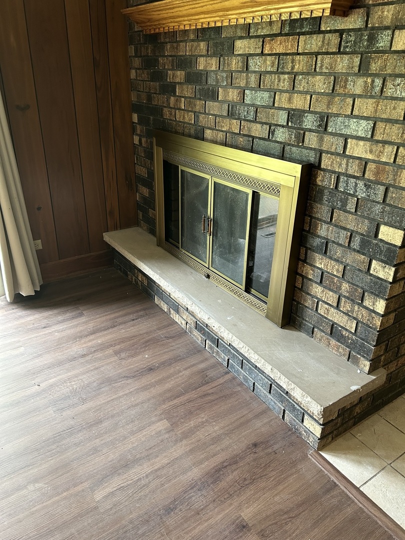1125 Morningside Drive Elgin, IL 60123 - Photo 24 of 42 a view of an empty room with wooden floor and a fireplace
