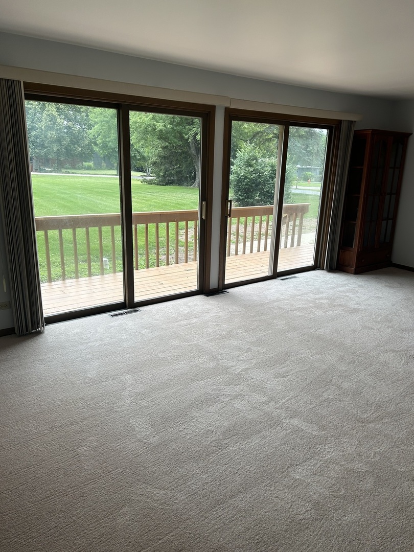 1125 Morningside Drive Elgin, IL 60123 - Photo 27 of 42 a view of an empty room with large windows and a balcony