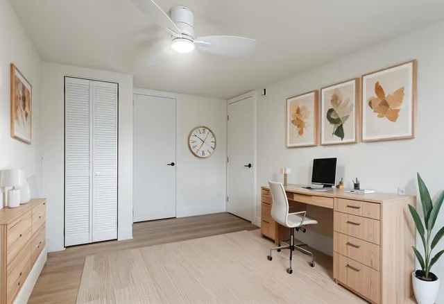 a view of a workspace with furniture and a window