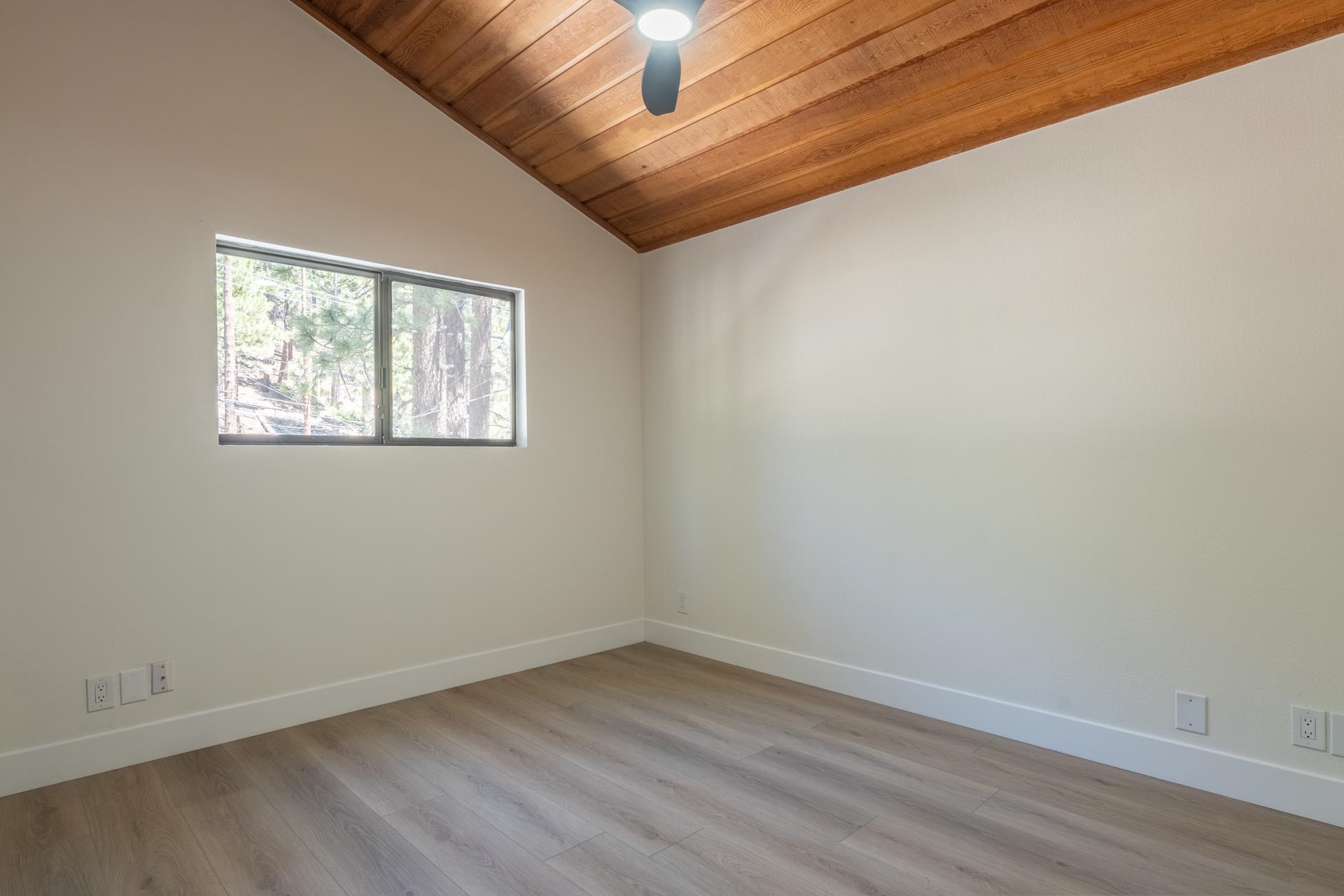 235 Forest Trail Mammoth Lakes, CA 93546 - Photo 18 of 35 Empty room featuring light wood-style floors, lofted ceiling, wood ceiling, and ceiling fan