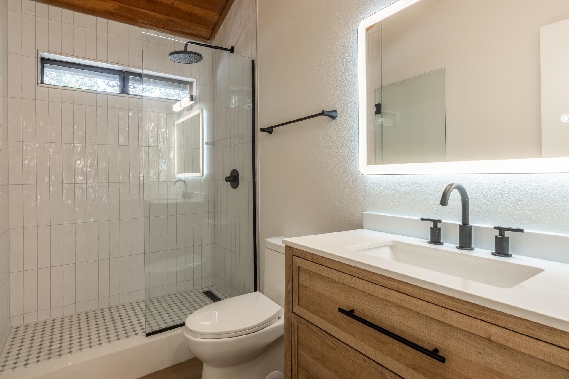 235 Forest Trail Mammoth Lakes, CA 93546 - Photo 19 of 35 Bathroom with a shower stall, vanity, and a textured wall