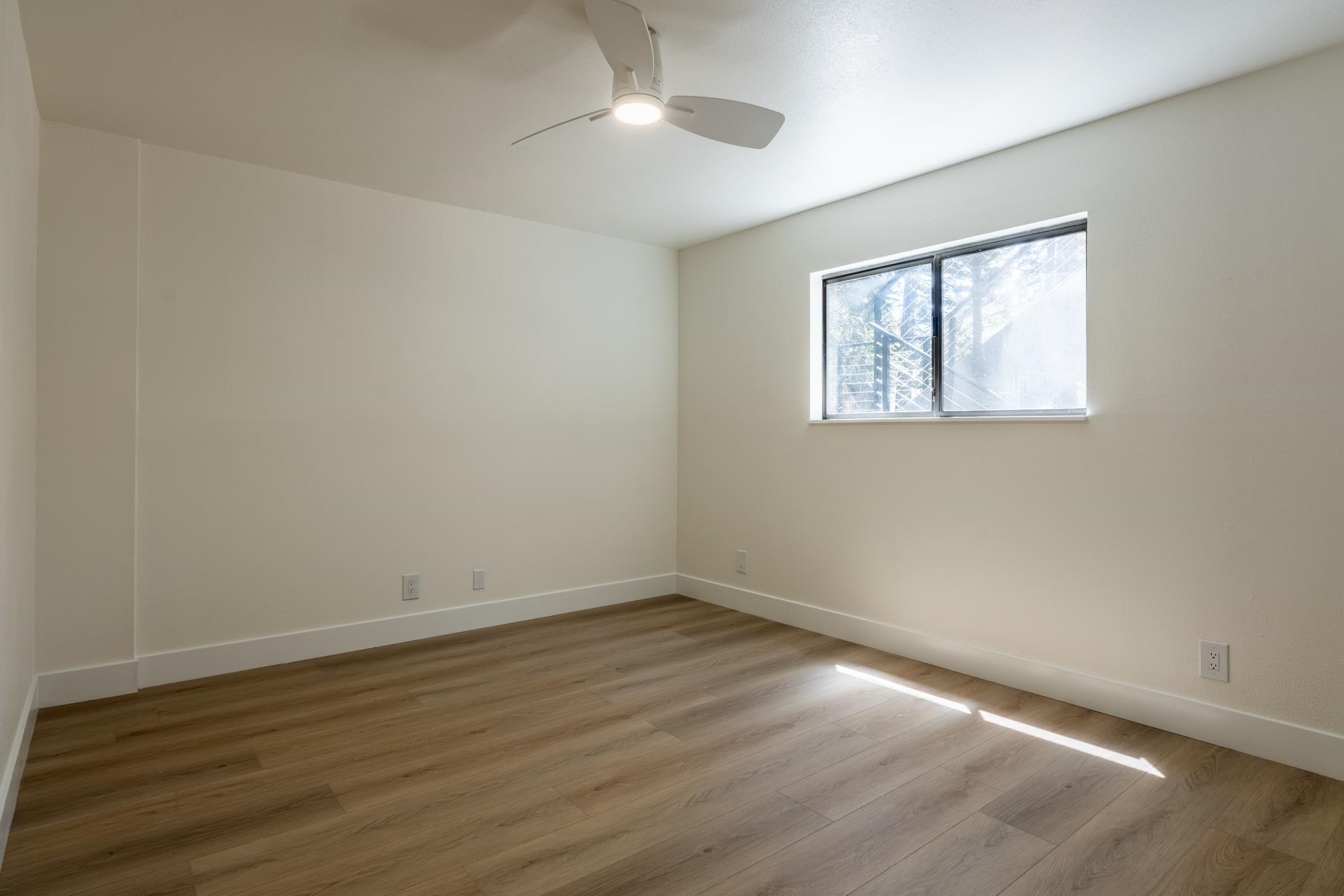 235 Forest Trail Mammoth Lakes, CA 93546 - Photo 21 of 35 Empty room featuring wood finished floors and a ceiling fan