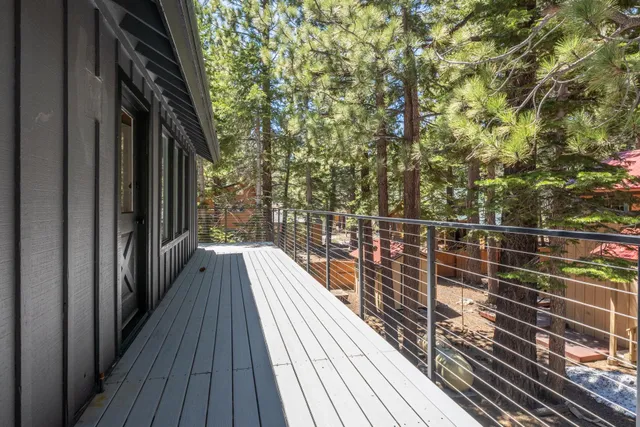 a view of balcony with wooden floor and fence