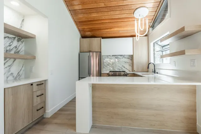 a view of a kitchen with a sink and wooden floor