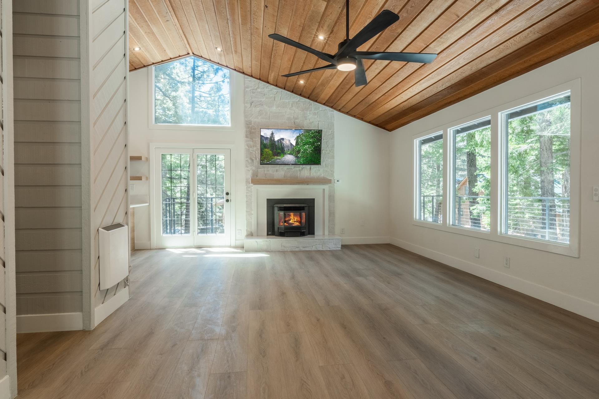 235 Forest Trail Mammoth Lakes, CA 93546 - Photo 7 of 35 Unfurnished living room featuring wood ceiling, light wood-type flooring, high vaulted ceiling, a fireplace, and recessed lighting