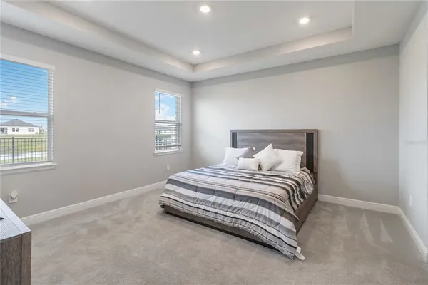 a spacious bedroom with a bed and a window