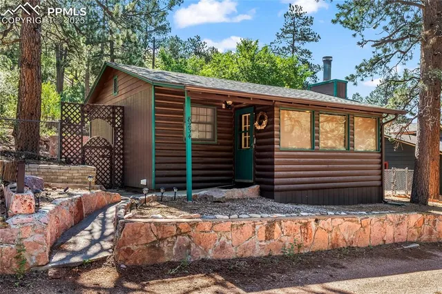 a view of house with backyard and wooden fence