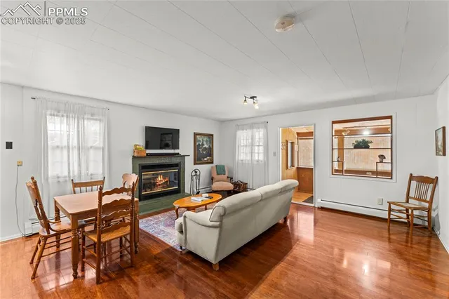 a living room with fireplace furniture and a flat screen tv