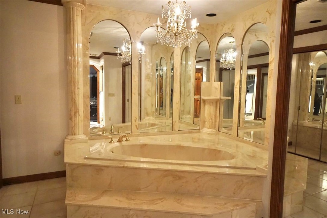 1760 Chartley Road Gates Mills, OH 44040 - Photo 20 of 49 Master bath soaking tub tile patterned floors, and a chandelier