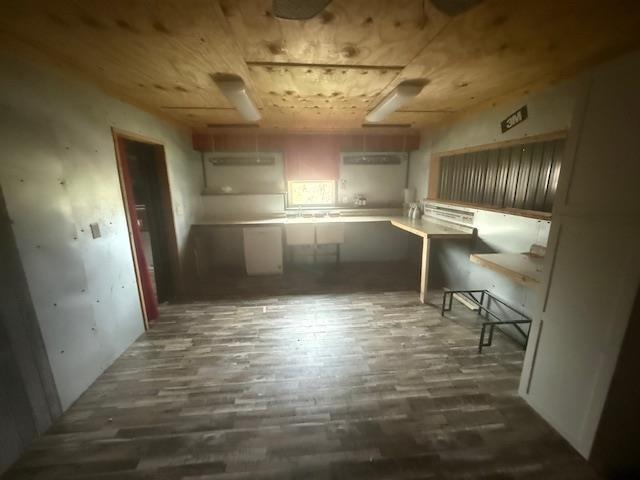 2310 Feddie Davis Road Ramer, TN 38367 - Photo 11 of 38 Kitchen with light countertops, dark wood finished floors, and a kitchen bar