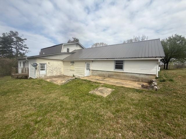 2310 Feddie Davis Road Ramer, TN 38367 - Photo 15 of 38 Back of property with a patio area, a yard, and a metal roof