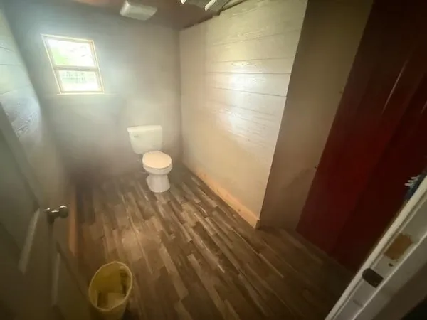 a bathroom with a granite countertop sink and a toilet