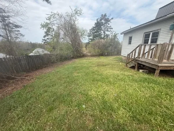 a view of a backyard with a garden and trees