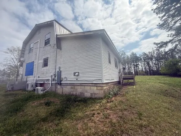 a backyard of a house with wooden floor and fence