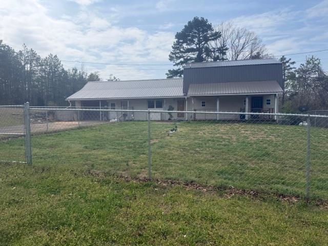 2310 Feddie Davis Road Ramer, TN 38367 - Photo 27 of 38 View of front facade featuring a fenced backyard and a metal roof