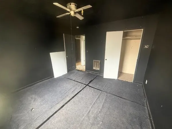 a view of a livingroom with a ceiling fan and window