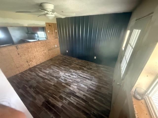 2310 Feddie Davis Road Ramer, TN 38367 - Photo 36 of 38 Unfurnished living room featuring a ceiling fan and dark wood-style flooring
