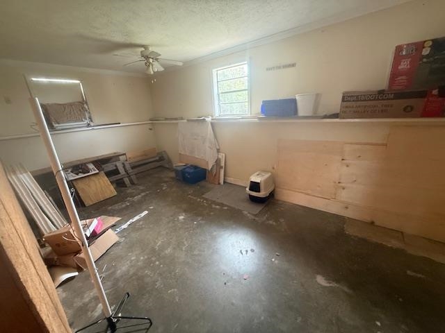 2310 Feddie Davis Road Ramer, TN 38367 - Photo 37 of 38 Miscellaneous room with ceiling fan, concrete floors, and a textured ceiling