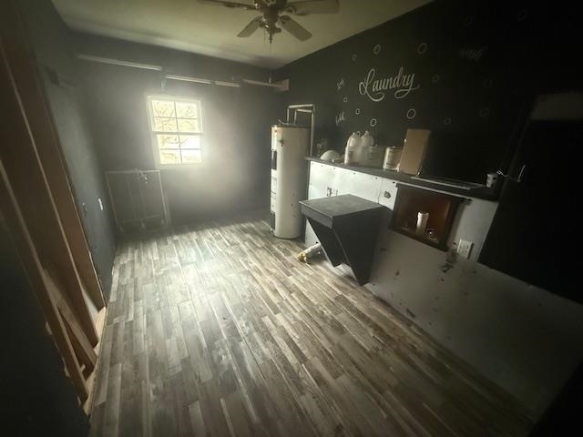 2310 Feddie Davis Road Ramer, TN 38367 - Photo 38 of 38 Unfurnished bedroom featuring water heater and dark wood-style flooring