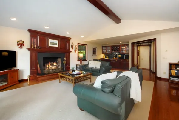 a living room with furniture a flat screen tv and a fireplace