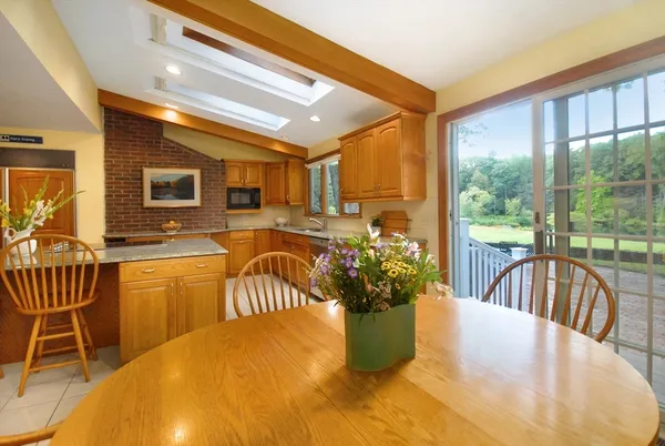 a view of a dining room with furniture a chandelier and wooden floor