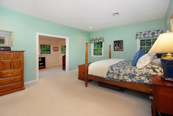 a bedroom with a bed and dresser