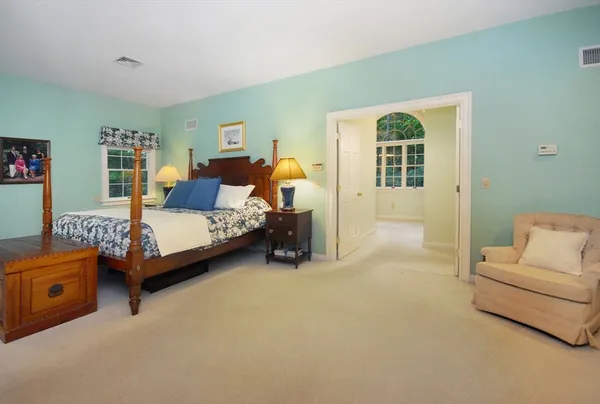a bedroom with a bed and a couch