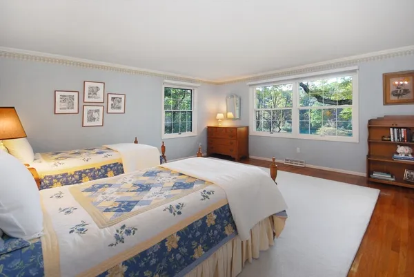 a bedroom with a bed and a large window