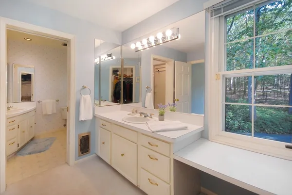 a spacious bathroom with a shower sink and mirror