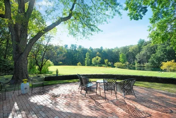 a view of a table and chairs in patio with a garden