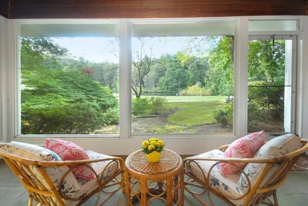 a view of a patio with swimming pool and furniture