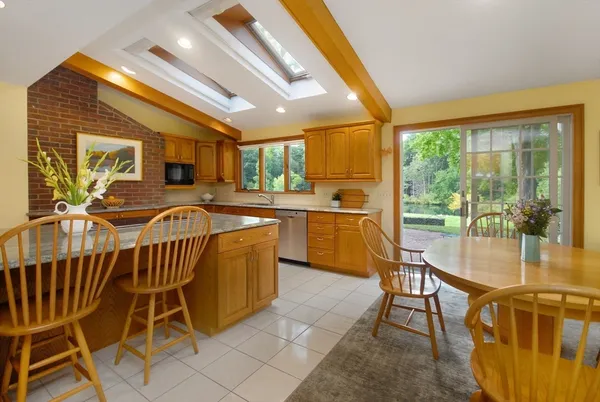 a dining room with furniture and large windows