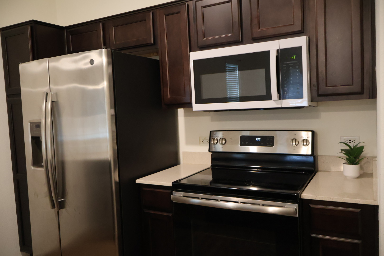 117 Galaxy Way Jarrell, TX 76537 - Photo 6 of 17 Modern kitchen featuring dark wood cabinetry and light countertops