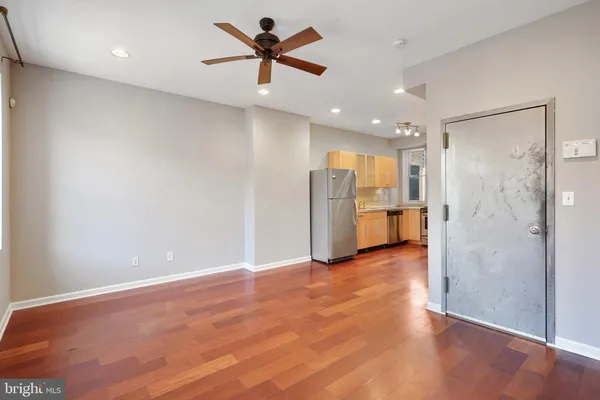 a view of an empty room with a kitchen