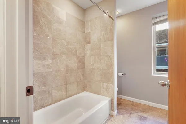 a bathroom with a bathtub and shower