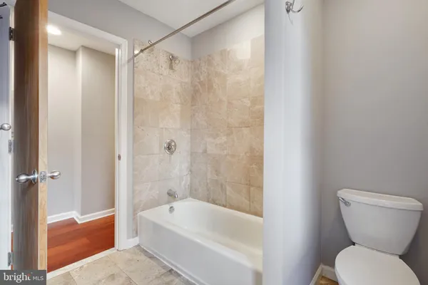 a bathroom with a toilet and a bathtub