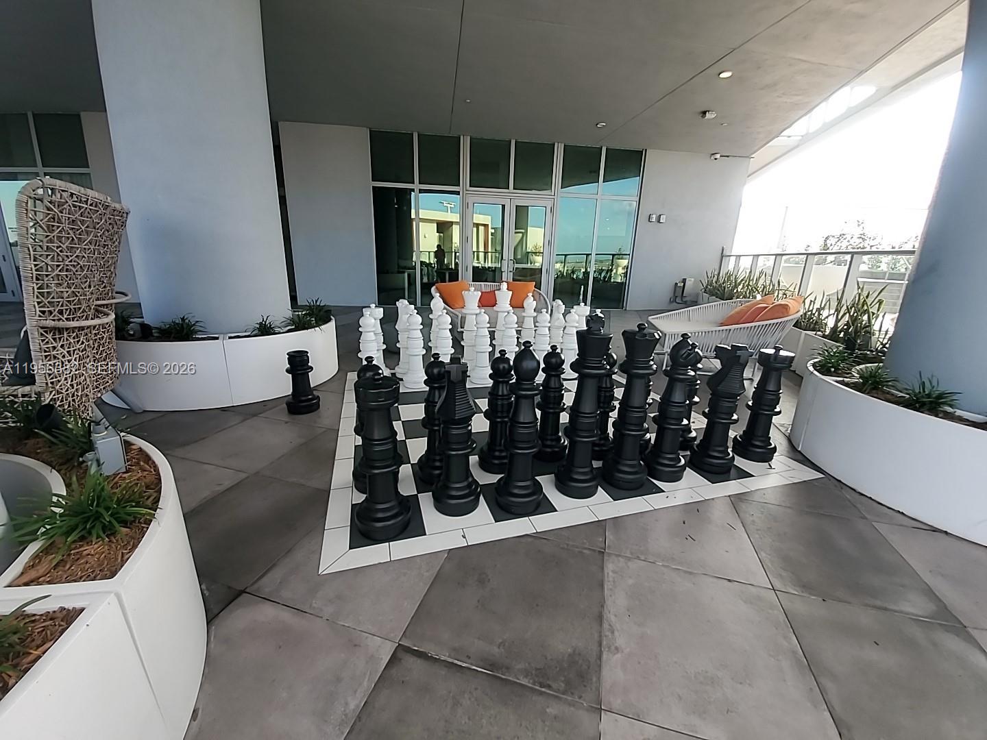 2000 Metropica Way, Unit 412 Sunrise, FL 33323 - Photo 12 of 18 a view of a chairs and tables in patio