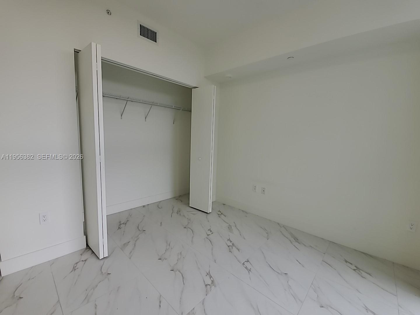 2000 Metropica Way, Unit 412 Sunrise, FL 33323 - Photo 7 of 18 an empty room with closet