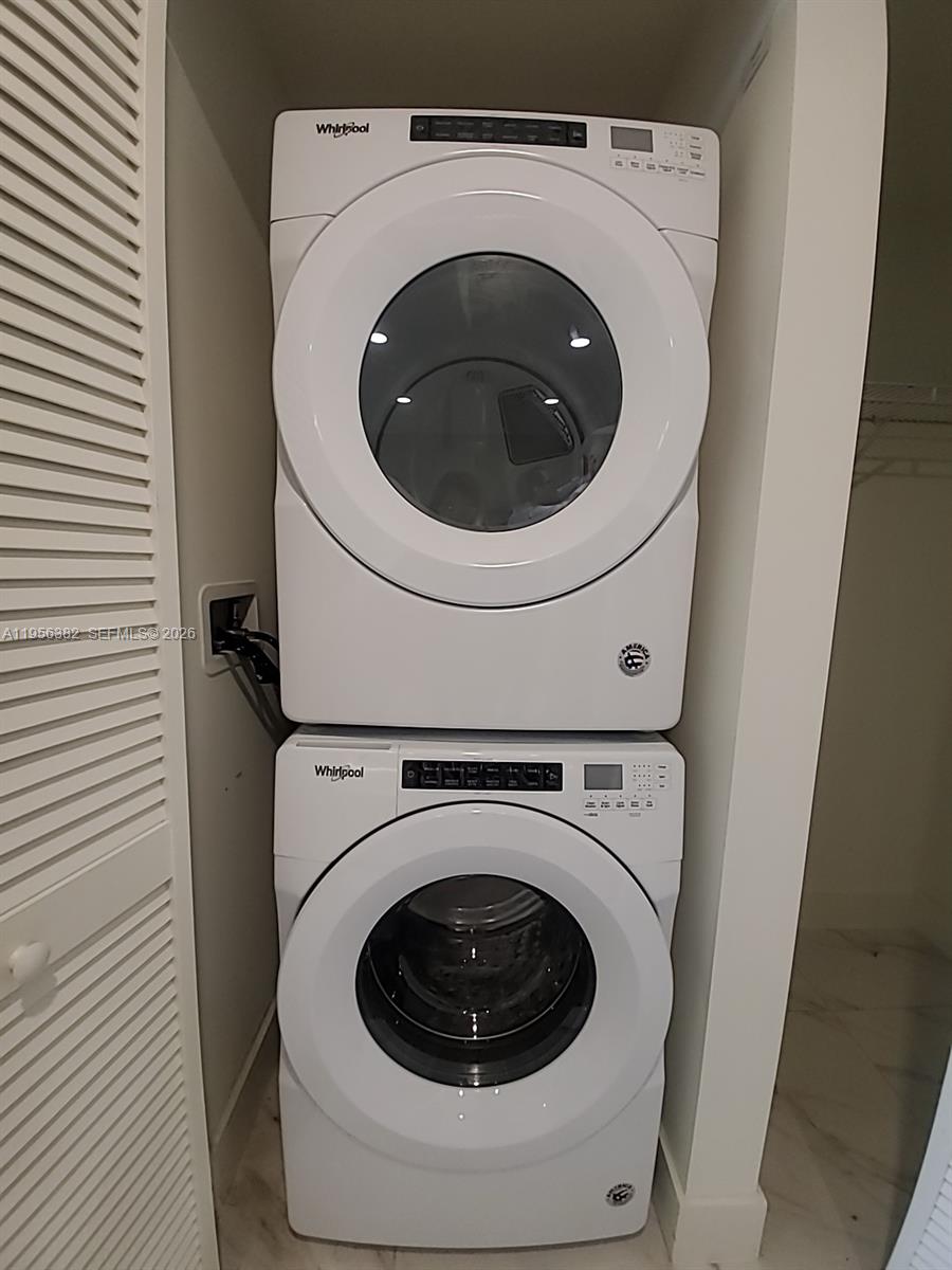 2000 Metropica Way, Unit 412 Sunrise, FL 33323 - Photo 9 of 18 a utility room with dryer and washer