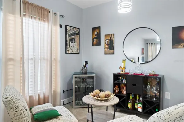 a living room with furniture and a mirror