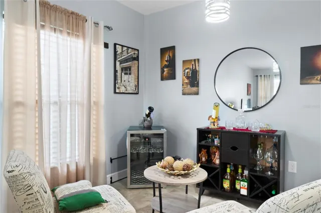 a living room with furniture and a mirror