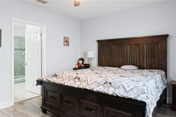 a bedroom with a bed and a dresser