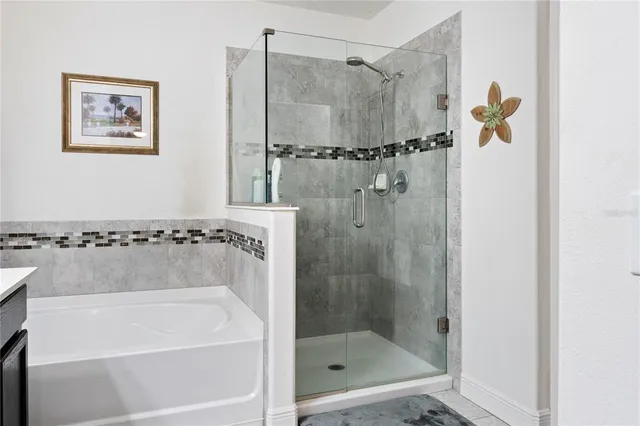 a bathroom with a shower and a bath tub