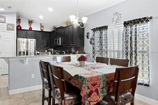 a dining room with a wooden table and chairs